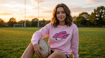 Woman on pitch grass in pink RG Impact sweatshirt RugbyGirl Impact collection review
