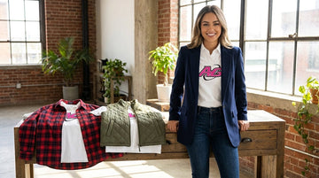 Stylish woman modeling layered women's rugby graphic tees with blazer and casual jacket options