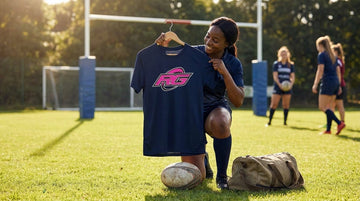 Woman holding breathable women's rugby tee with RG Impact print on hanger