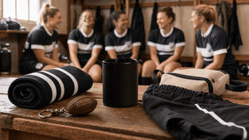 Affordable rugby gifts for women including ceramic mug and accessories arranged on locker room bench