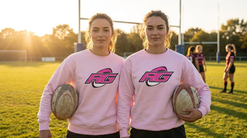Woman on rugby pitch wearing pink RG Impact sweatshirt guide to rugby sweatshirts