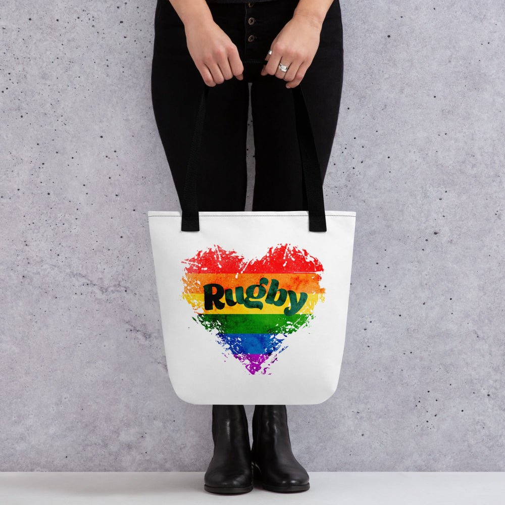 White tote bag with rainbow heart and bold "Rugby" text, perfect rugby gift for her, women's rugby apparel accessory. - Rugby Girl