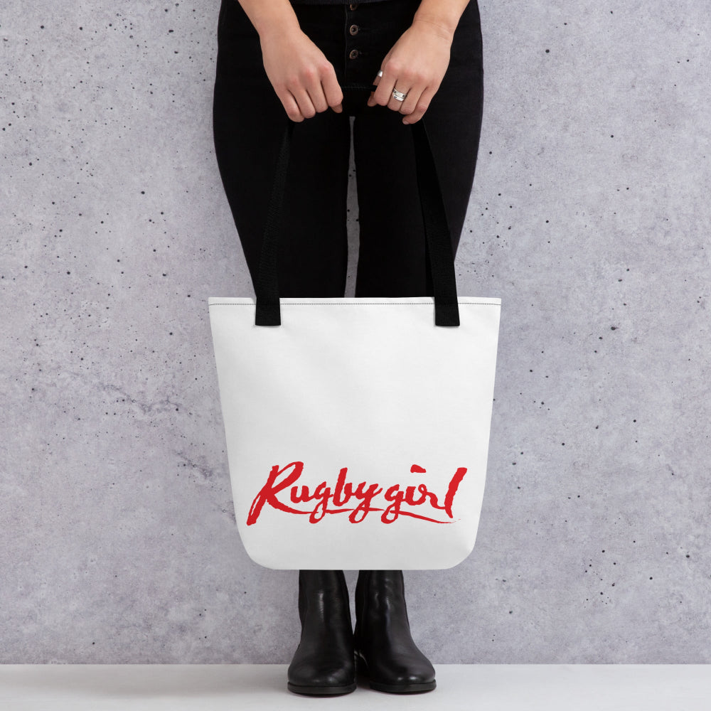 White tote bag with bold red "Rugby girl" script, black handles, women's rugby apparel gift accessory. - Rugby Girl