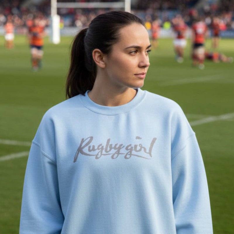 Light blue women's rugby sweatshirt with "Rugby girl" script, casual rugby apparel for fans. - Rugby Girl