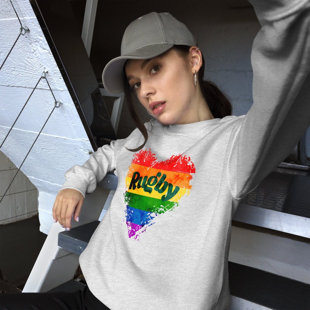 Light gray women's rugby sweatshirt with colorful rainbow heart and "Rugby" text, casual rugby girl style. - Rugby Girl