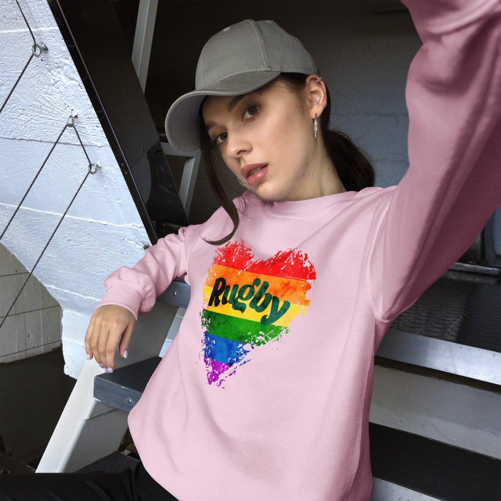 Light pink women's rugby sweatshirt with rainbow heart and bold Rugby Girl Pride Love graphic. - Rugby Girl