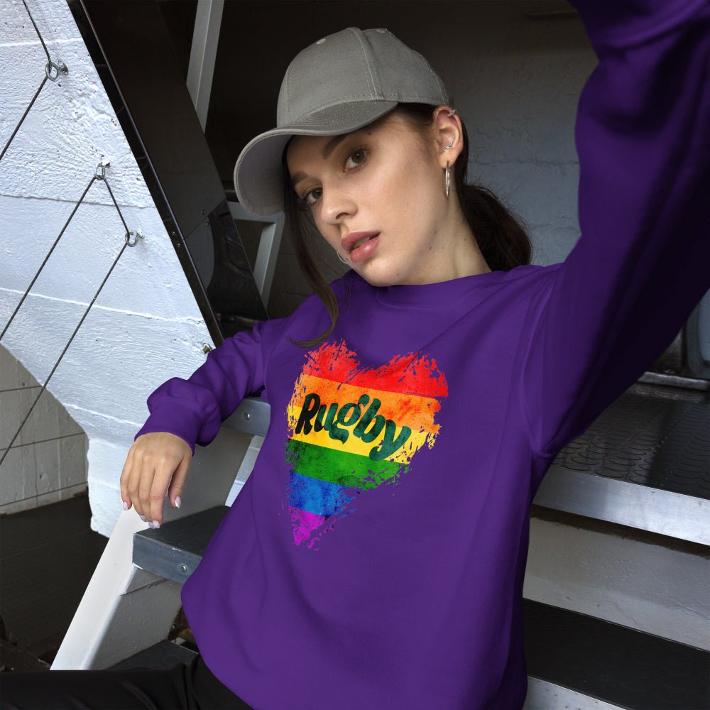 Purple women's rugby sweatshirt with rainbow heart and bold Rugby Girl text, casual style. - Rugby Girl