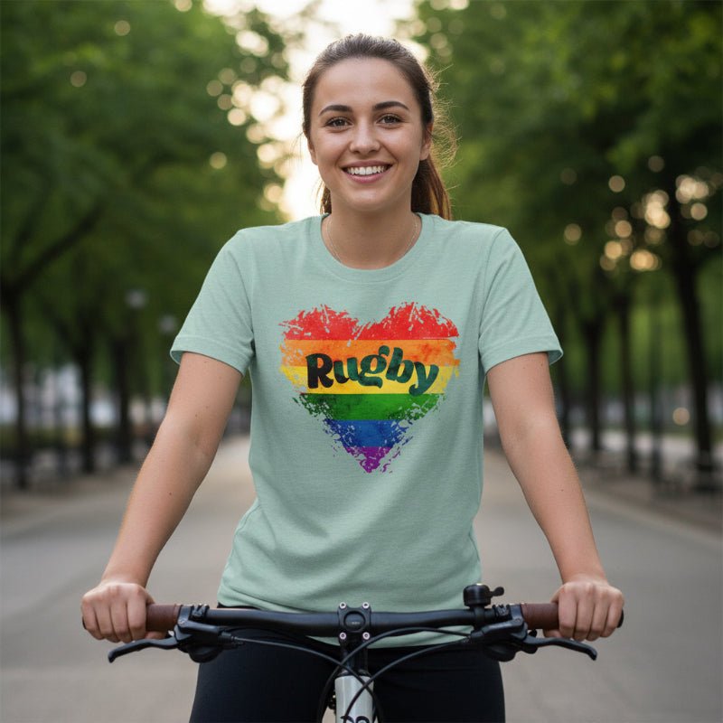 Heather green women's rugby t-shirt with rainbow heart and bold Rugby Girl Pride Love design. - Rugby Girl