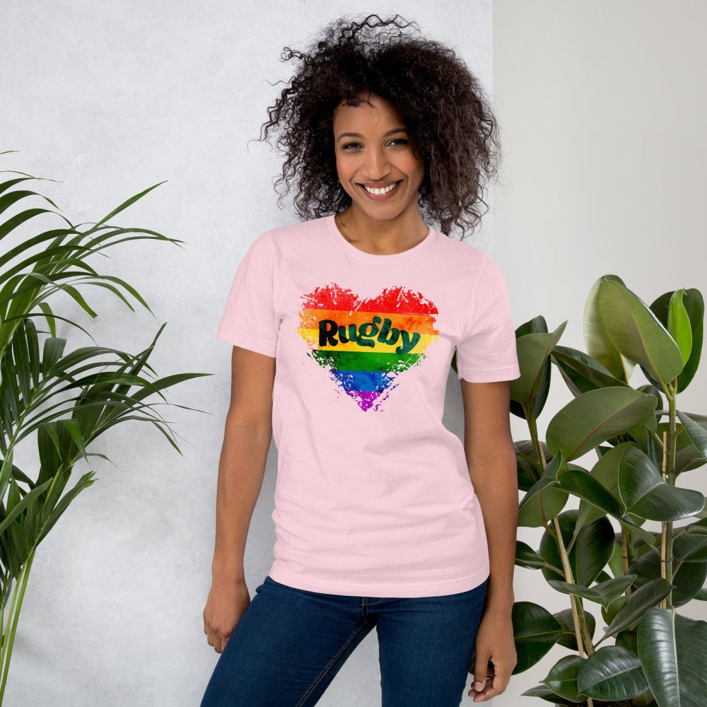 Soft pink women's rugby t-shirt with vibrant rainbow "Rugby" heart design, casual fit. - Rugby Girl