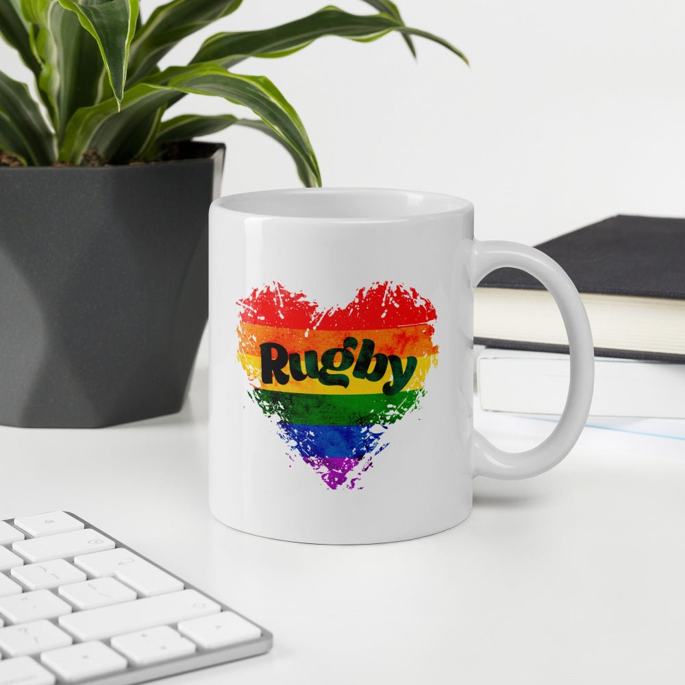 White ceramic mug with rainbow heart and "Rugby" text, perfect rugby gift for her. - Rugby Girl