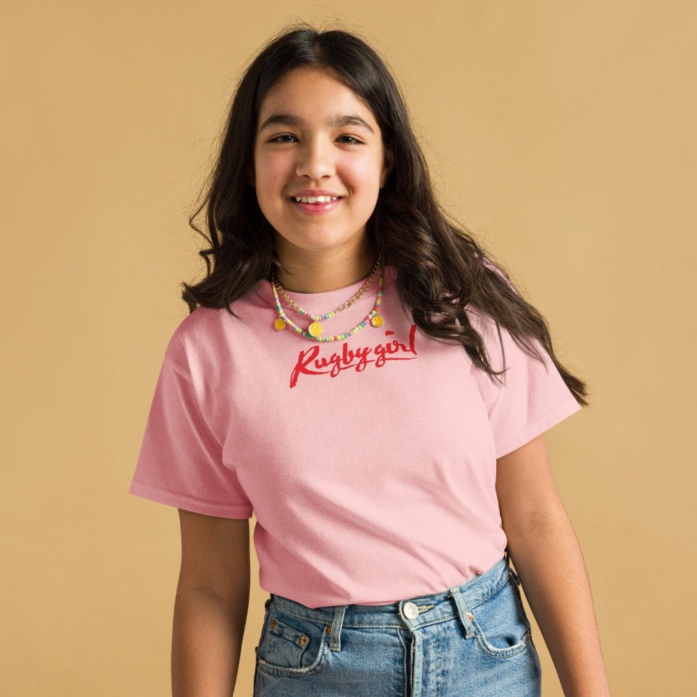 Light pink girl's rugby t-shirt with red "Rugby Girl" script, styled casually with jeans. - Rugby Girl